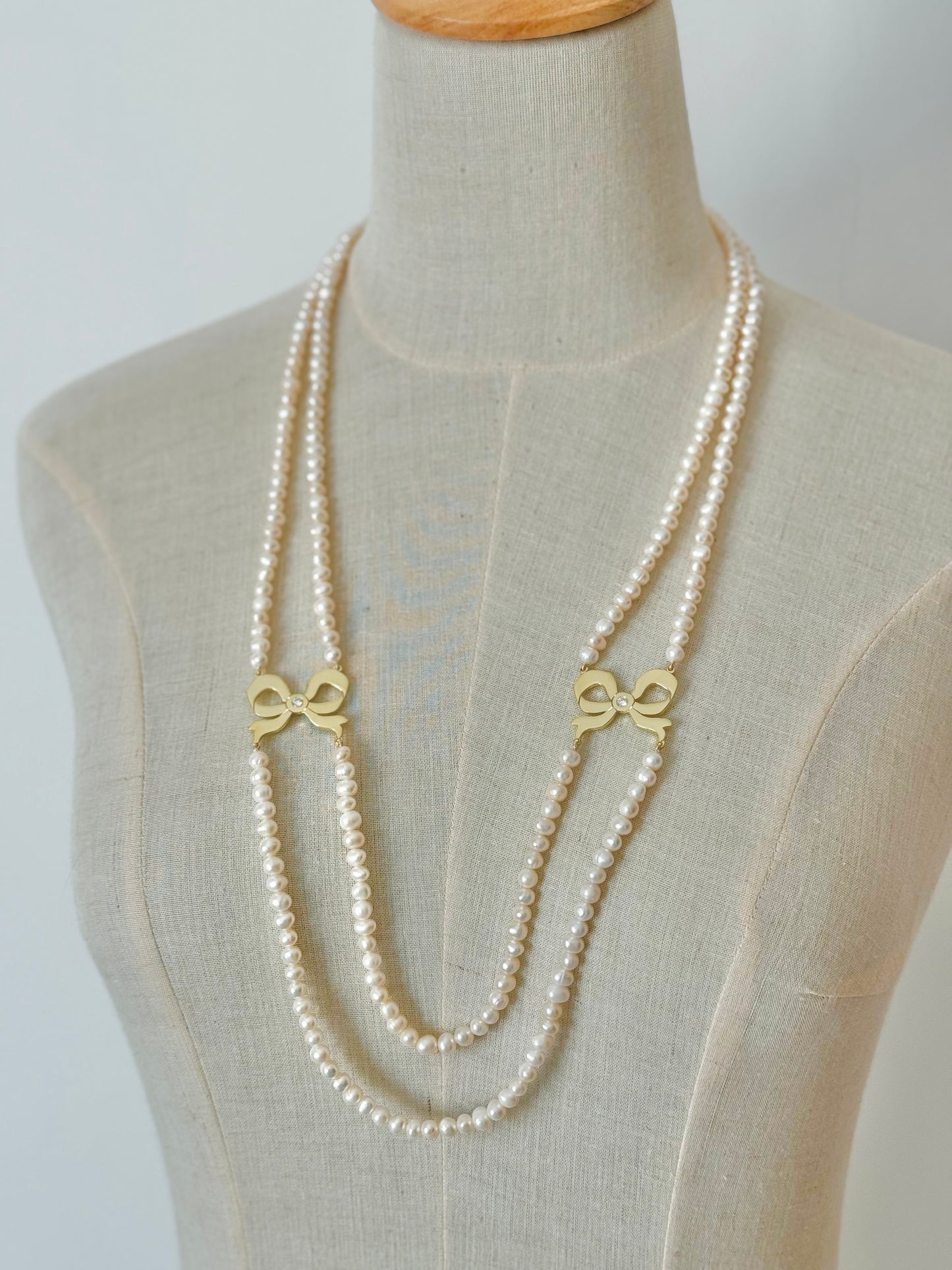 Gold plated silver Bows in 2 lines of real fresh water Pearls