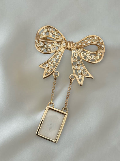 Vintage gold bow brooch with crystals and hanging frame