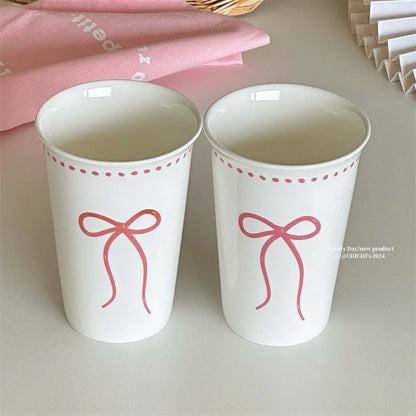 Long white ceramic glass with bow design